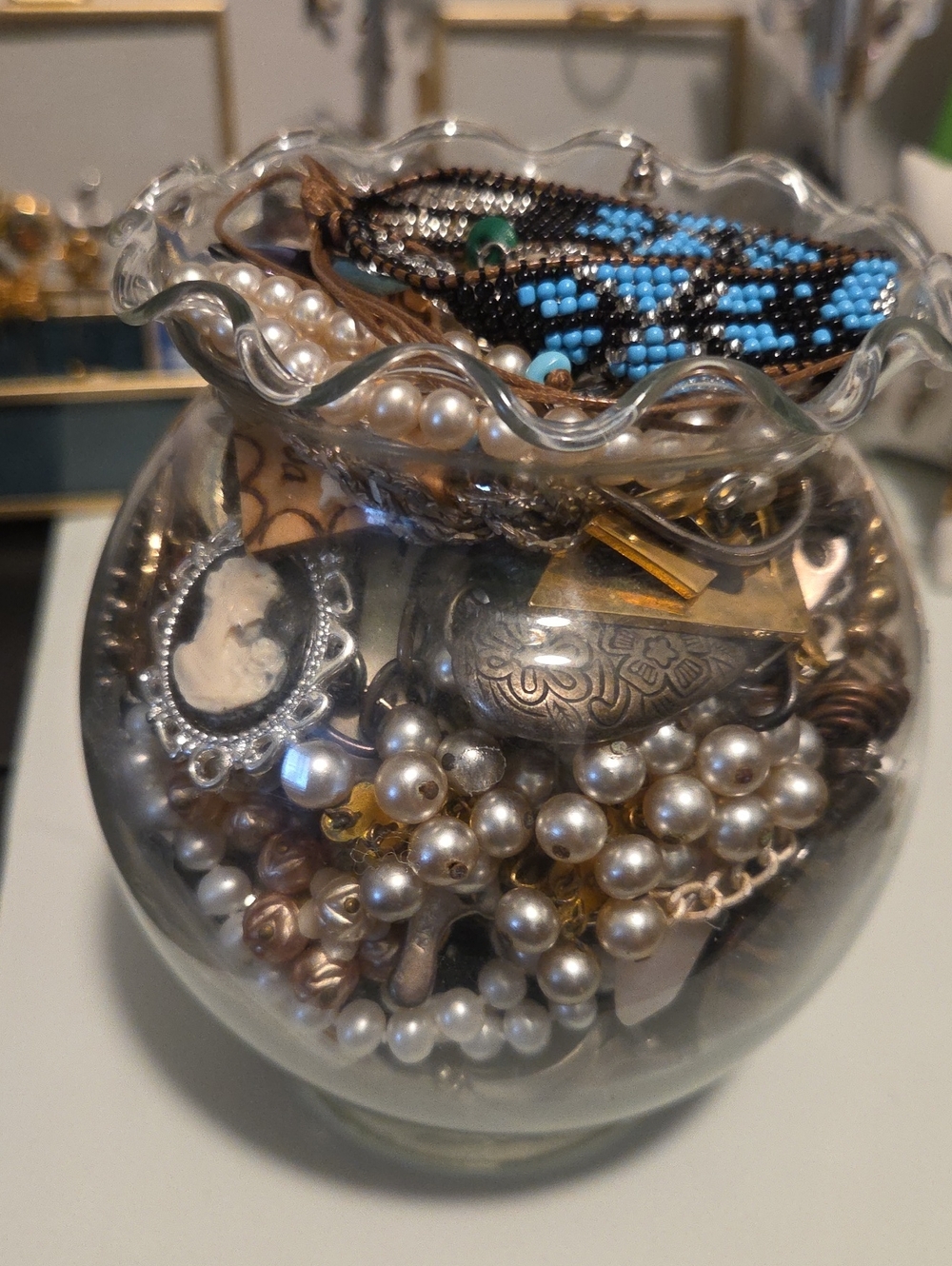 Clear Glass Bowl Filled With Jewelry